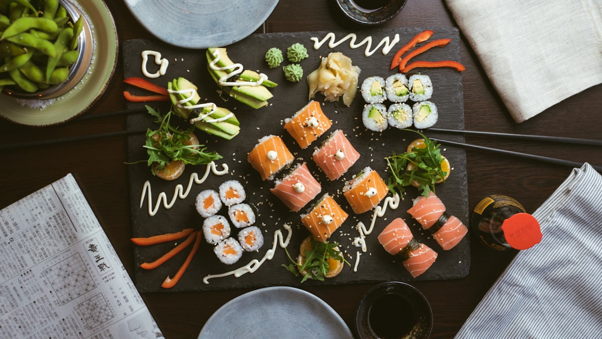 Assorted maki and nigiri on a dark platter